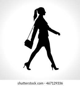 Vector black silhouette of walking businesswoman, isolated