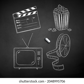 Vector black and white chalk drawn illustration set of movie symbols on black chalkboard background.