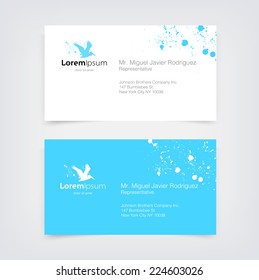 Vector blue business card design template with flying pelican silhouette logo and paint splatter