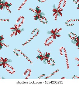 Vector blue candy cane decorated with ribbons seamless Christmas background pattern. Perfect for fabric, scrapbooking and wallpaper projects.
