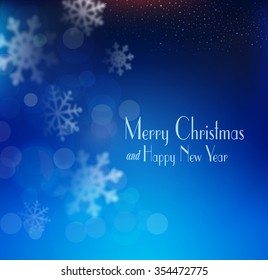 vector blue Christmas background with snowflakes blurred in the background