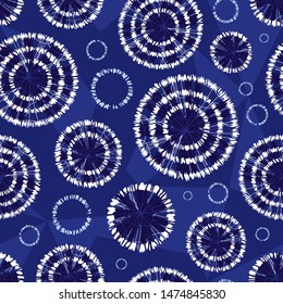 Vector blue shibori circle wheels abstract seamless pattern with geometric background. Suitable for textile, gift wrap and wallpaper.