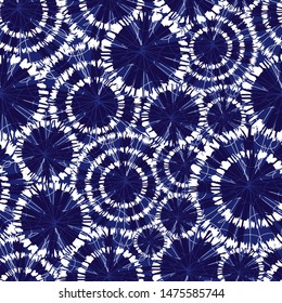 Vector blue shibori circle wheels overlap seamless pattern. With spiderweb detail. Suitable for textile, gift wrap and wallpaper.