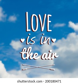 Vector blurred illustration with clouds, blue sky and text "Love is in the air"