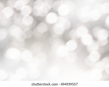 Vector bokeh background. Festive defocused white lights. Abstract blurred illustration.