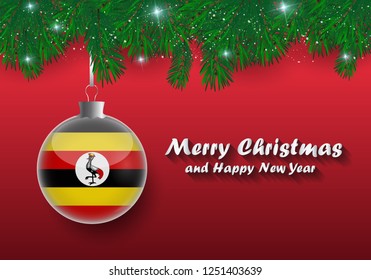 Vector border of Christmas tree branches and ball with uganda flag. Merry christmas and happy new year. 