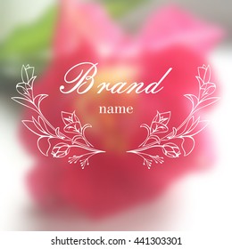 Vector botanical logo,label,emblem on the blurred background. It can be used for floral shop or natural organic cosmetics. Brand identity. Hand drawn illustration