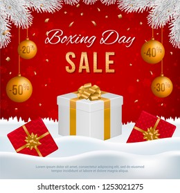 Vector Boxing Day sale banner with gift boxes, New Year golden balls, white fir branches and text on winter background.