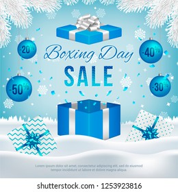 Vector Boxing Day sale banner with gift boxes, New Year blue balls, white fir branches and text on winter background.