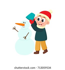 vector boy makes snowman smiling. Flat cartoon isolated illustration on a white background. Happy kid having fun playing with snow outdoors. Winter children activity concept