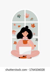Vector brunette woman drinking a cup of tea or coffee and working on laptop by window with autumn leaves