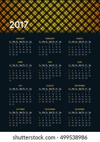 Vector calendar for 2017 year on dark background with shiny yellow pattern in header. Week starts on sunday