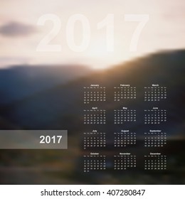 Vector calendar template. 2017 year. Blurred nature background. Week starts on Monday, calendar page, wall poster with hills backdrop.