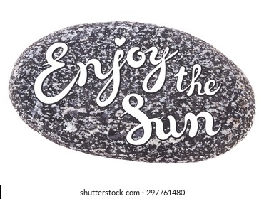 Vector calligraphic inscription on sea pebbles background - ENJOY THE SUN poster or greeting card - exclusive hand written vector lettering collection