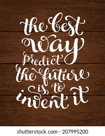 Vector calligraphic inscription with ornamental elements on wood background. "The best way predict the future is to invent it" poster or postcard. Typography collection
