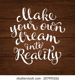 Vector calligraphic inscription with ornamental elements on wood background. "Make your own dream into reality" poster or postcard. Typography collection