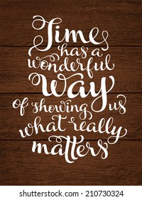 Vector calligraphic inscription with ornamental elements on wood background. "Time has a wonderful way of showing us what really matters" poster or postcard. Typography collection