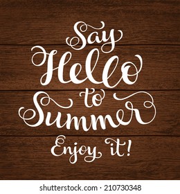 Vector calligraphic inscription with ornamental elements on wood background. "Say Hello to Summer. Enjoy it!" poster or postcard. Typography collection, vacation illustration