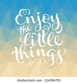 Vector calligraphic inscription with ornamental elements on colorful geometric background. "Enjoy the little things" poster or postcard. Typography collection