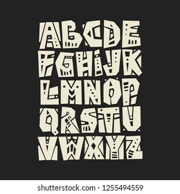 Vector capital cut out alphabet. White letters decorated with geometric patterns on a black background.