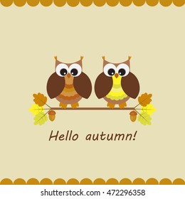 Vector card with autumn theme. A pair of owls sitting on the branches of an oak with acorns.