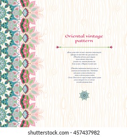 Vector card with border on wooden backdrop. Traditional indian flower. Hand drawing. Place for your text.
