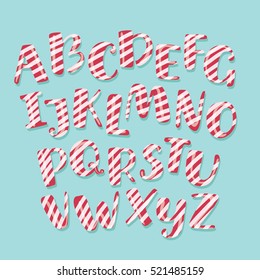 Vector cartoon funny Christmas striped candy alphabet letters. White and red stirpes on blue background