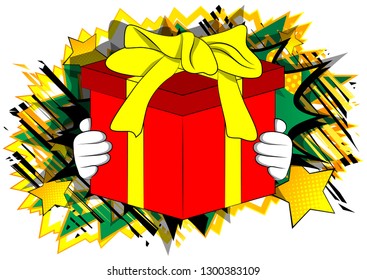 Vector cartoon hand holding big gift box. Illustrated holiday sign on comic book background.