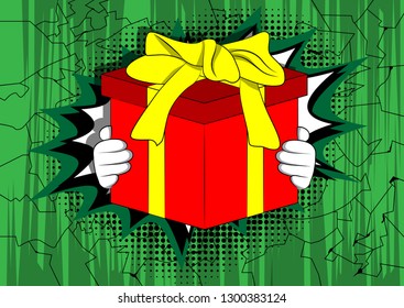 Vector cartoon hand holding big gift box. Illustrated holiday sign on comic book background.