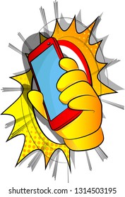 Vector cartoon hand holding a cell phone. Illustrated hand with smart phone on comic book background.