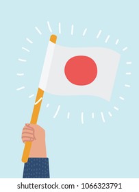 Vector cartoon illustration of human hand holding and raising the national flag of Japan.