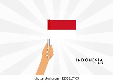 Vector cartoon illustration of human hands hold indonesia flag. Isolated object on white background.