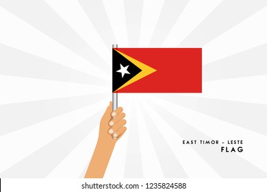 Vector cartoon illustration of human hands hold East Timor flag. Isolated object on white background.