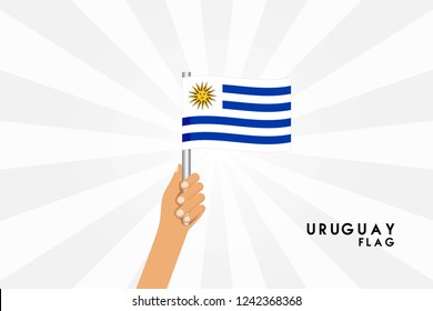Vector cartoon illustration of human hands hold Uruguay flag. Isolated object on white background.