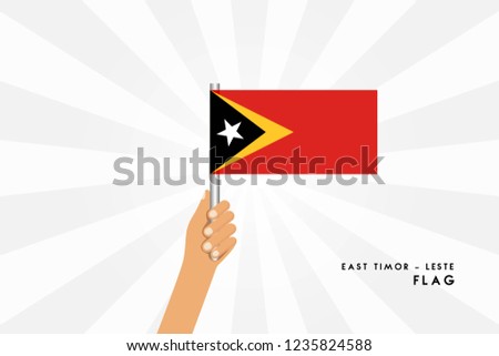 Vector cartoon illustration of human hands hold East Timor flag. Isolated object on white background.