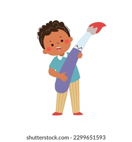 Vector cartoon little student boy holding big paintbrush. Back to school concept