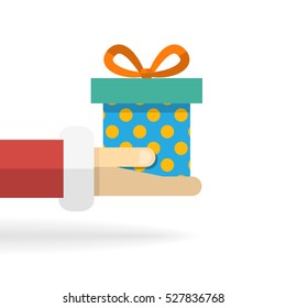 Vector cartoon Santa Claus hand with gift with polka dots isolated on a white background with shadow in flat style