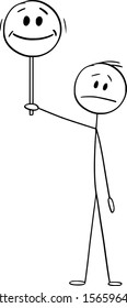 Vector cartoon stick figure drawing conceptual illustration of unhappy or frustrated man or businessman holding and showing happy face sign.