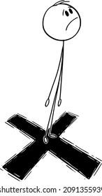 Vector cartoon stick figure drawing conceptual illustration of man or businessman standing on cross or big X mark as target for shooting.