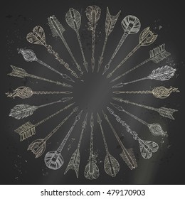 Vector chalk ethnic arrows round frame. Hand-drawn tribal arrows arranged in a circle on blackboard background. Boho and hippie style illustration.