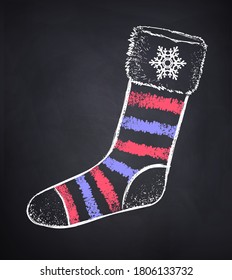 Vector chalked illustration of striped Christmas sock on black chalkboard background.