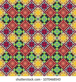 Vector checkered fabric texture print in shades of red, yellow and brown. Seamless tartan plaid pattern.