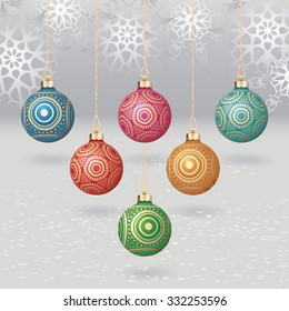 Vector christmas balls with gold design on light background with flakes