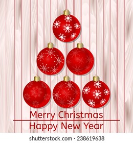 Vector Christmas card with Christmas balls in form of abstract Christmas tree on wooden background. Eps10