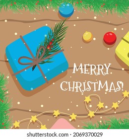 Vector Christmas card with a gift, a garland and Christmas tree toys on a wooden table