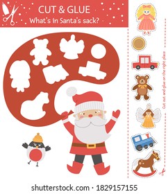 Vector Christmas cut and glue activity. Winter educational crafting game with cute Santa Claus, Bullfinch and toys. Fun activity for kids. What’s in Santa’s sack?
