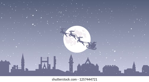 vector christmas eve in the town illustration, santa claus flying in sleigh with reindeers, full moon and snow falling over buildings