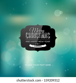 Vector christmas greeting card - black shiny label over a teal blurred unfocused photographic background