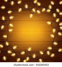 Vector Christmas lights on wooden texture background with copyspace