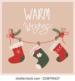 Vector christmas and new year card with hanging christmas socks new year symbols. Illustration with warm wishes lettering